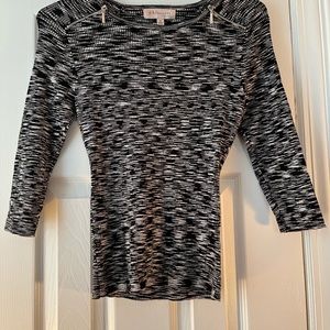 Like new black and white stretchy philosophy womens shirt zippers at the top.